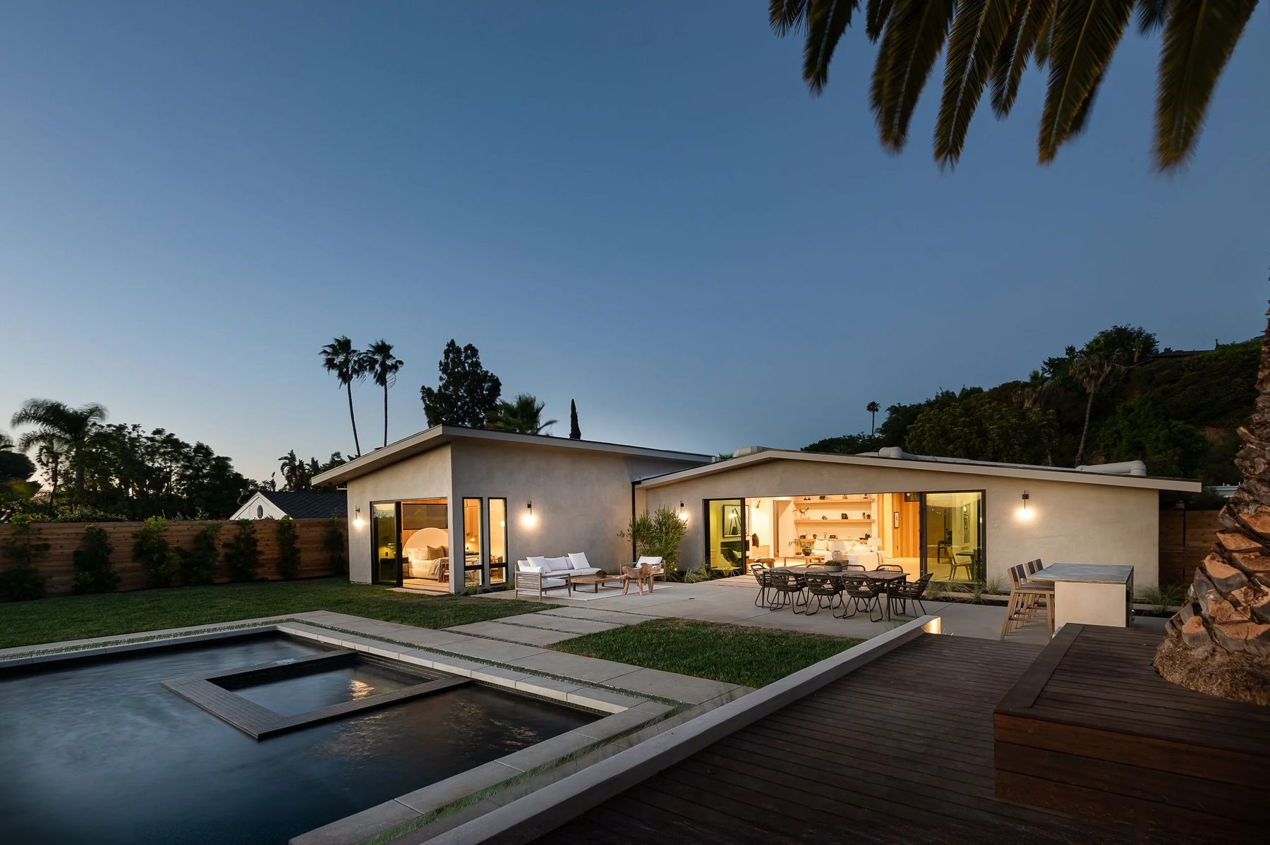 Modern post-and-beam residence at dusk with reflecting pool, built by the design lab in Los Angeles